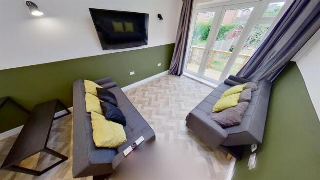 Bright living room with comfortable sofas and T...