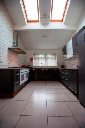 Modern kitchen with skylights and sleek units...