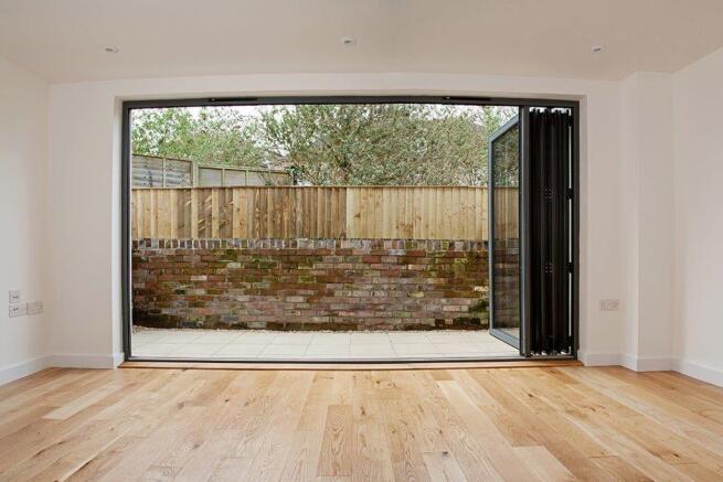 Bright living room with stunning bi-fold doors...