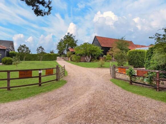 Gated gravel entrance drive leading to The Tithe B