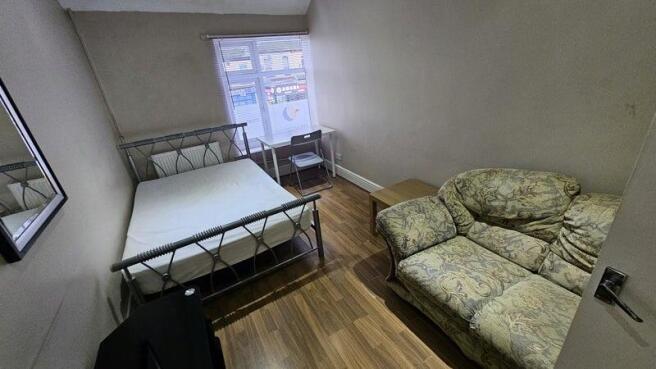 A cozy double bedroom featuring a double metal-...