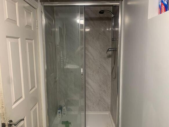Modern walk-in shower with sleek marble tiling....