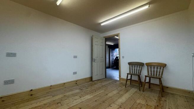 Versatile workspace with charming wood flooring...
