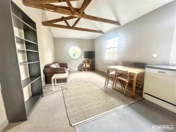 Bright living room with vaulted timber beams...