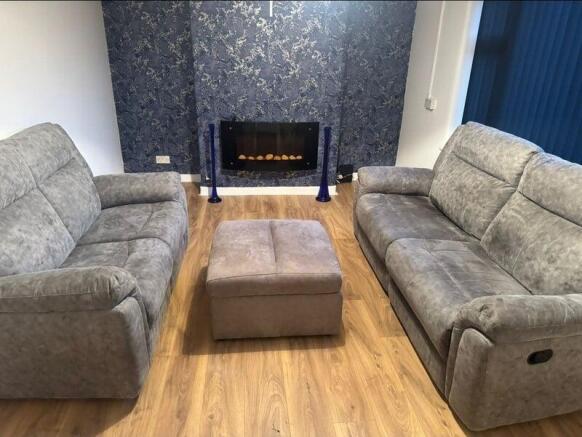 Modern lounge with comfy sofas and electric fir...