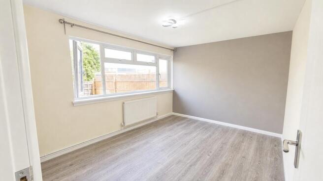 Bright double bedroom with modern grey flooring...