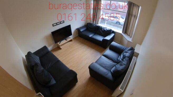 Bright, well-maintained living room with two co...