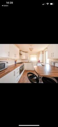Modern kitchen with ample counter space and sea...