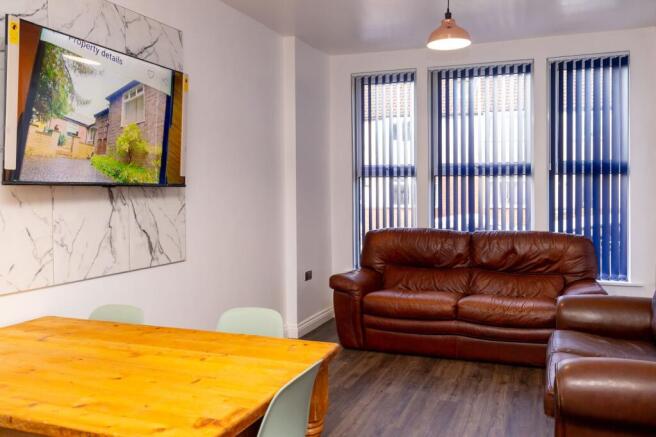 A spacious and welcoming living room featuring ...