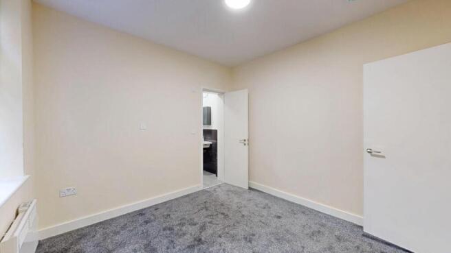 Neat, freshly decorated bedroom with neutral wa...