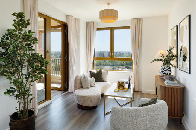 Living area photograph with door towards balcony and large window with views towards London