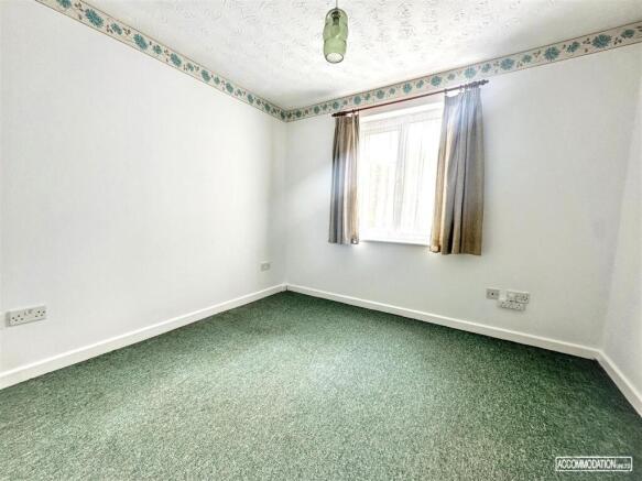 Bright and airy bedroom with large window...