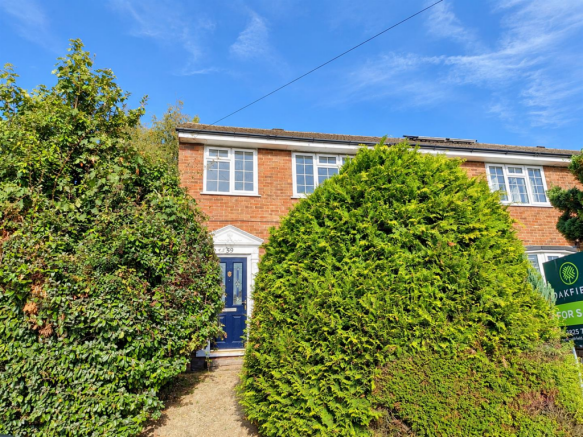 Brick House Framed by Lush Hedges.png