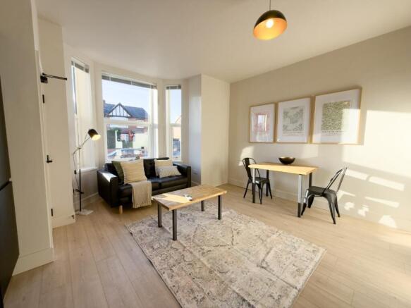 Bright, modern living room with large bay windo...