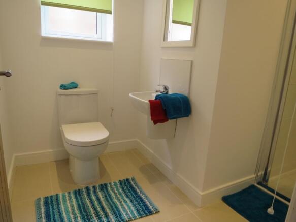 Bright and tidy bathroom featuring a toilet, sm...