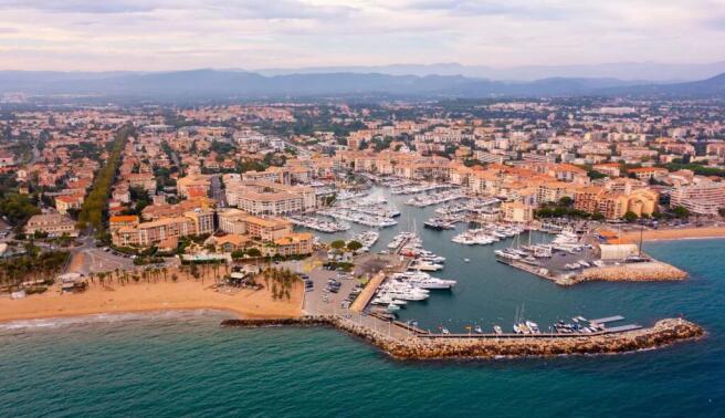 Aerial cityscape of France city Frejus with yachts