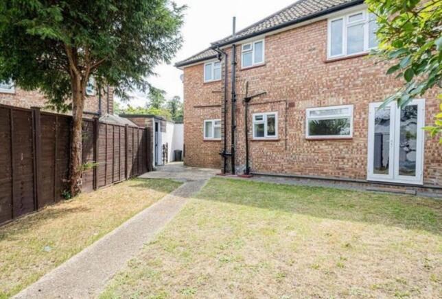 Private rear garden with a paved pathway, lawn ...