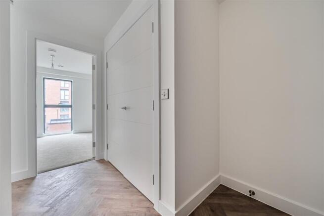 Bright modern hallway with stylish wood floorin...