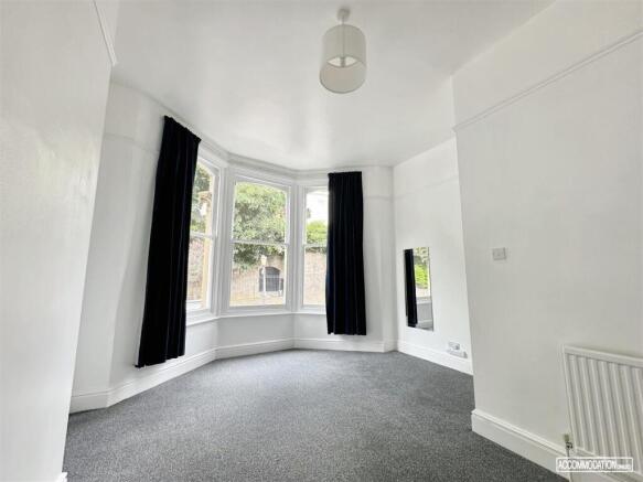 Bright bedroom with large classic bay window...