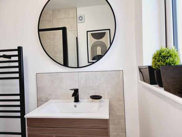 A beautifully designed bathroom featuring a sle...