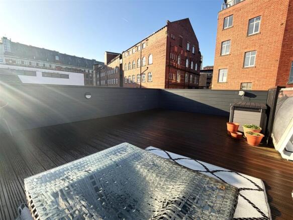 Spacious sun-drenched roof terrace with decking...