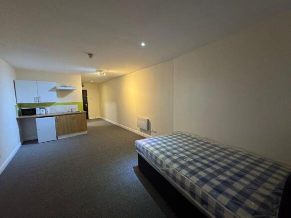 Spacious living area featuring a comfortable sl...