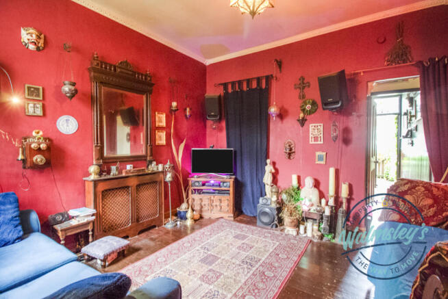 Rear sitting room towards stairs and frontage