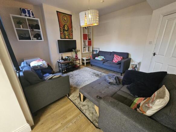 Bright, well-furnished living room with multipl...