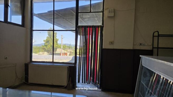 Inside view showing large window and doorway with a striped curtain hanging