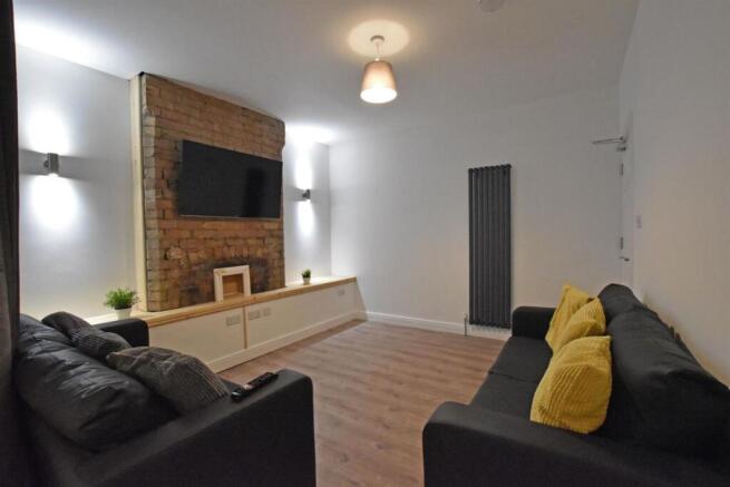 Stylish modern living room with exposed brick w...