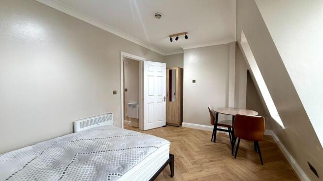 Bright, freshly painted double bedroom with her...