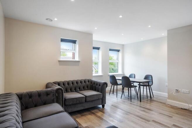 Elegant living area with plush seating and dini...