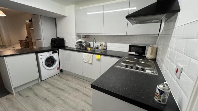 Modern kitchen with sleek white cabinetry...