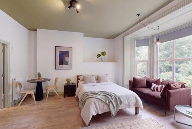 Elegant master bedroom with bright bay window...