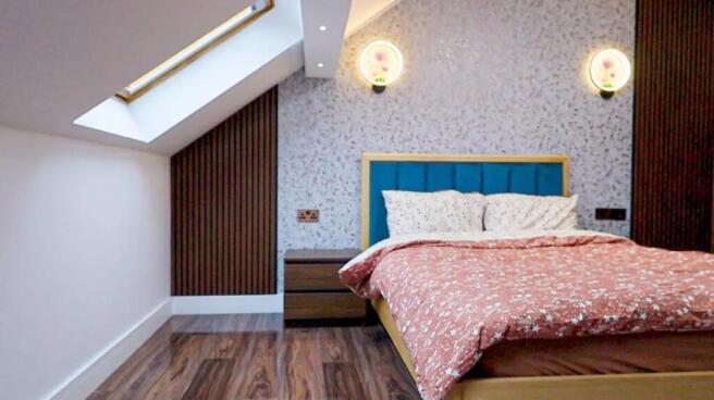 Bright, stylish attic double bedroom with a sky...