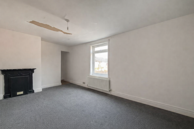 Empty Room With Damaged Ceiling And Fireplace T202602251112.png