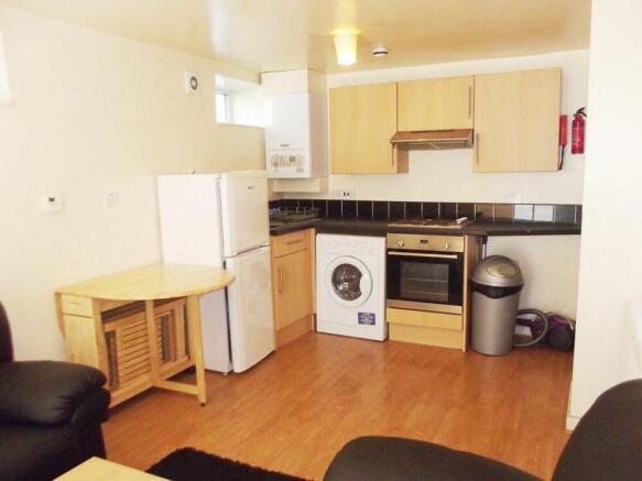 Bright kitchen with modern appliances and dinin...