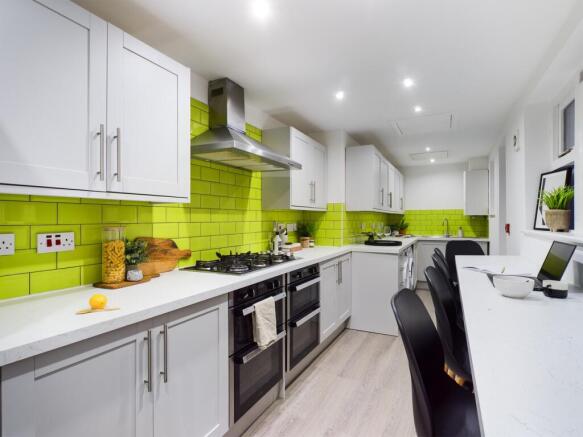 A modern and spacious kitchen featuring vibrant...