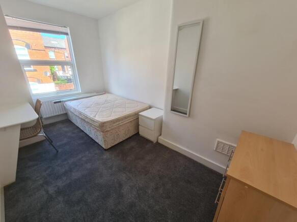 Bright and tidy double bedroom featuring a comf...