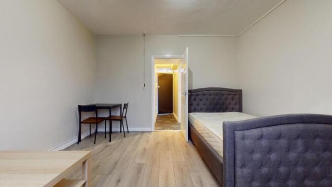 Bright, tidy bedroom with a stylish upholstered...