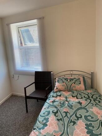 Bright bedroom with stylish patterned bedding...