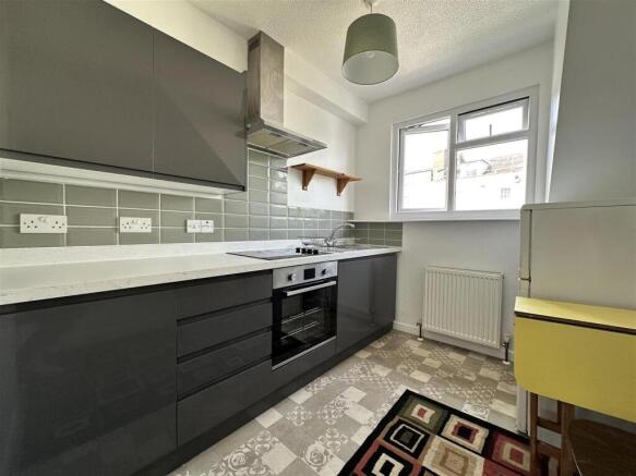 Modern kitchen with sleek cabinetry and natural...