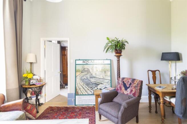 Bright lounge with high ceilings and study desk...