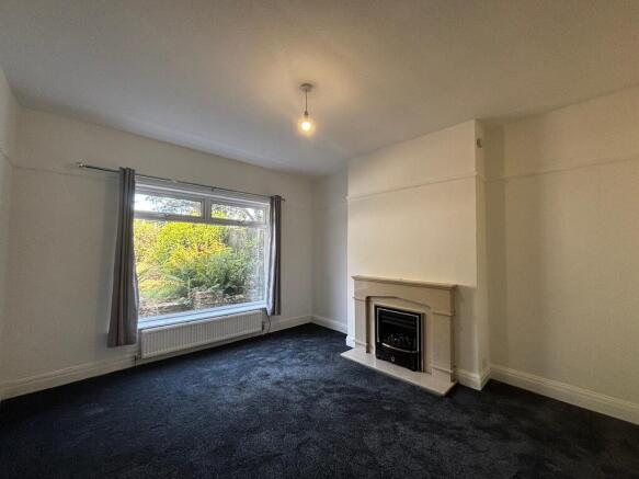 Spacious living room with a feature fireplace...