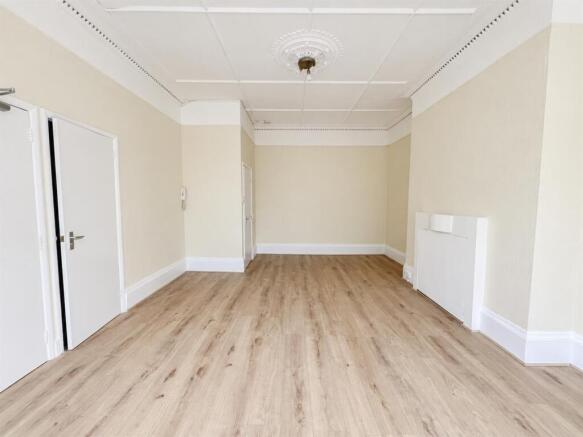 Empty Cream Room with Ornate Ceiling Details.jpg