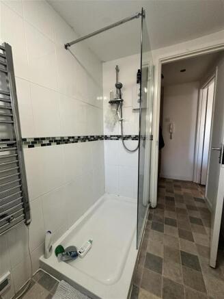 Modern tiled shower with sleek glass enclosure...