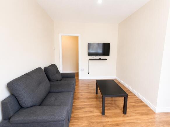 Bright living room with comfy sofa and smart TV...
