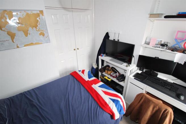 Bright bedroom with workspace and ample storage...