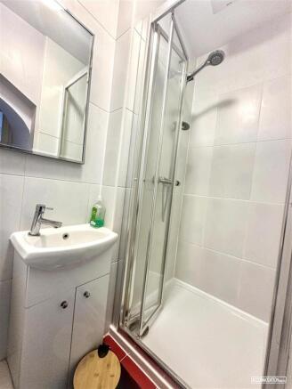 Bright and modern shower room with tiled walls...