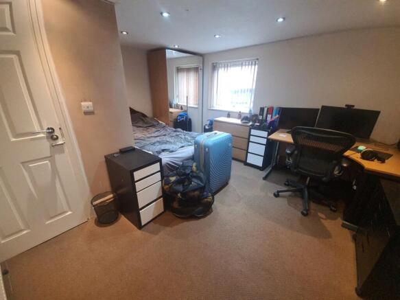 A spacious and comfortable living room featurin...